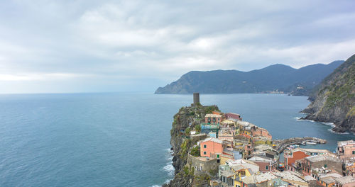 High angle view of townscape by sea against sky