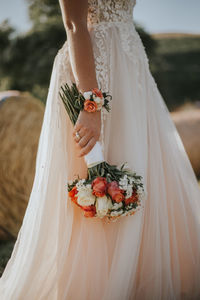 Midsection of woman holding bouquet