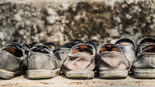 Children's school shoes in a row on the ground outside a classroom in a thai remote village