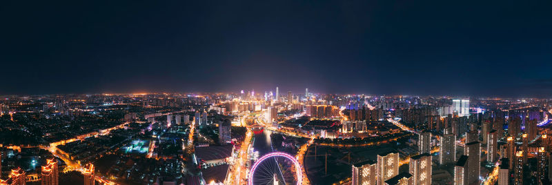 High angle view of city lit up at night