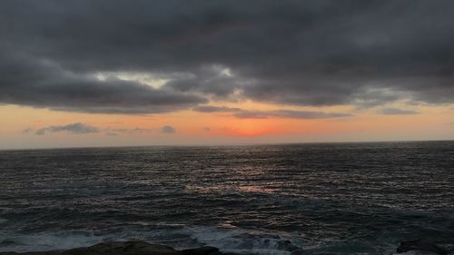 Scenic view of sea against sky at sunset