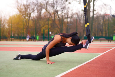Full length of woman exercising outdoors