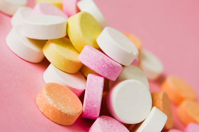 Close-up of pills over pink background