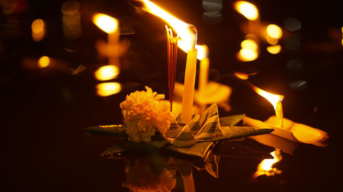 Loi krathong festival of thailand floating flowers and candle for apologies in river full moon night