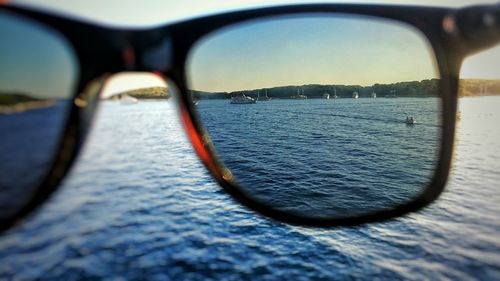 Close-up of reflection of water in mirror against sky