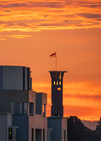 Low angle view of building against orange sky during sunset