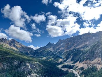 Scenic view of mountains against cloudy sky