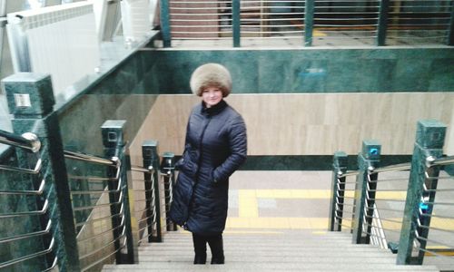 Portrait of man standing on railing