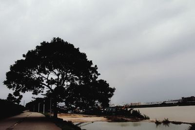 Empty road against cloudy sky