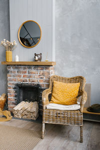 Grey living room and yellow room with fireplace and wooden decor. the style of the living room 