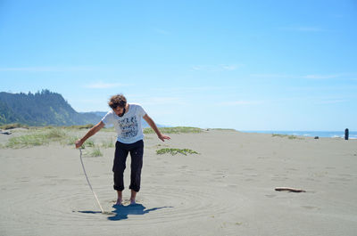 Full length of woman standing on beach