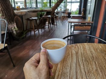 Midsection of coffee cup on table