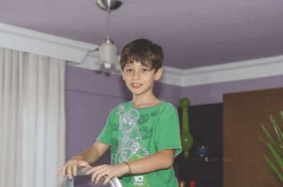 Portrait of young man standing at home