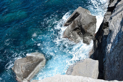 High angle view of rocks by sea