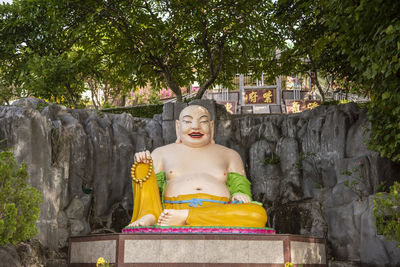 Low angle view of statue against trees