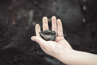 Close-up of hand and an artifact at an archeological site