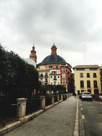 Buildings against cloudy sky