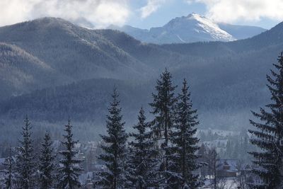 Scenic view of snow covered mountains against sky