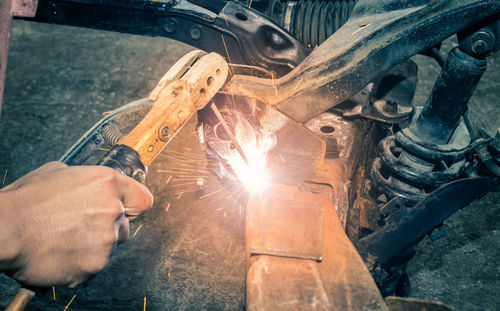 Low angle view of man working on metal