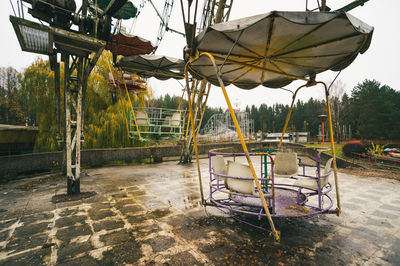 Swing ride in park against sky