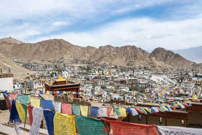 View of multi colored houses in town against sky