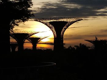 Silhouette bridge against sky during sunset