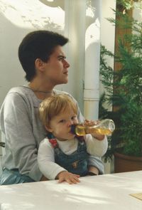 Father and son on table at home