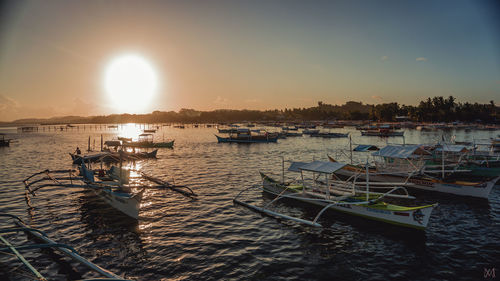 Boats in marina at sunset