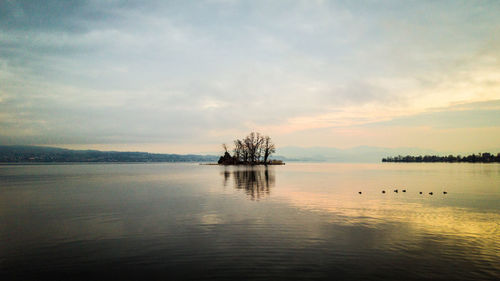 Scenic view of lake against sky during sunset