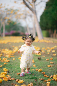 Full length of cute baby girl running on land