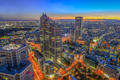 High angle view of city lit up at night