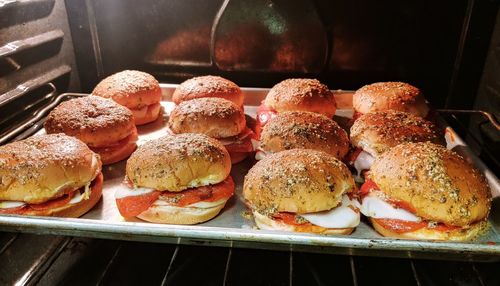 Burgers arranged on baking sheet