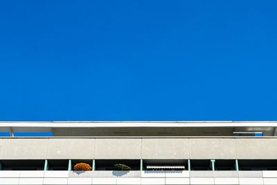 Low angle view of building against clear blue sky