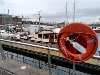 View of ship moored at harbor against sky