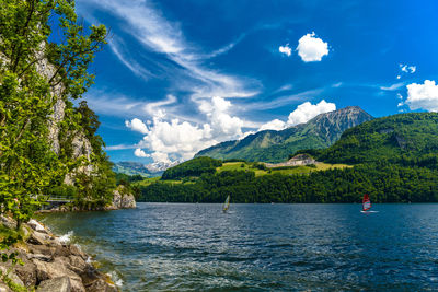 Scenic view of sea and mountains against sky