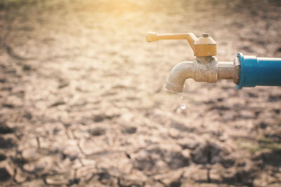 Close-up of faucet in water