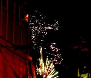 Low angle view of firework display at night