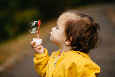 Portrait of boy holding yellow outdoors