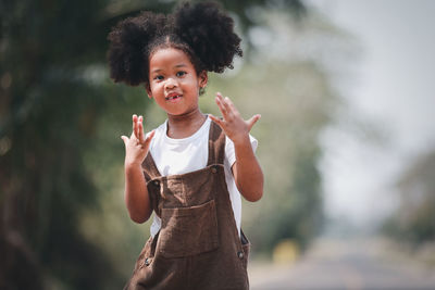 Portrait of cute girl standing outdoors