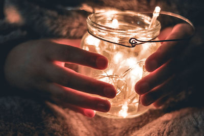 Close-up of hand holding candle
