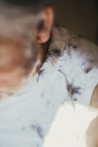 Cropped image of man with hair on shoulder at barber shop