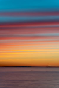 Scenic view of sea against orange sky