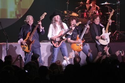 People playing guitar at music concert