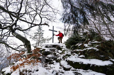 Man standing on snow covered peak 