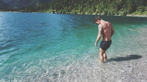 Full length of man standing in water