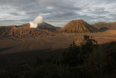 Panoramic view of arid landscape against sky