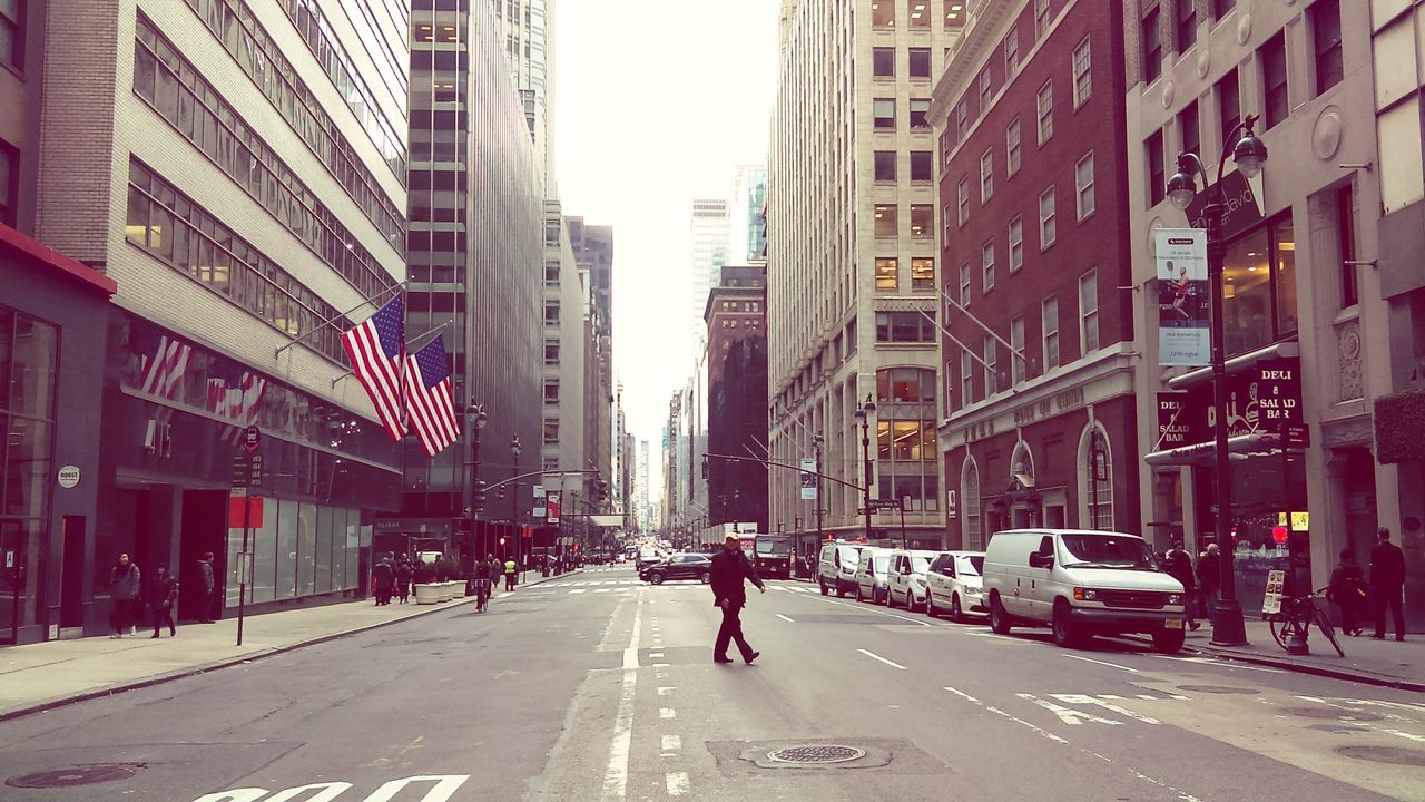 city, building exterior, street, city street, architecture, city life, travel destinations, built structure, skyscraper, outdoors, adults only, people, yellow taxi, one person, day, adult, one man only