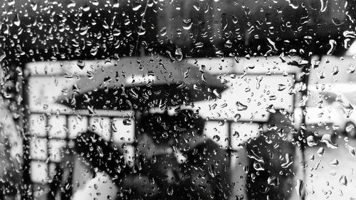 Close-up of wet glass window in rainy season