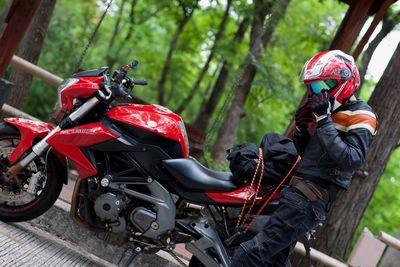 Motorcycle parked against trees