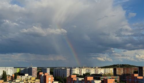 Rainbow over buildings in city